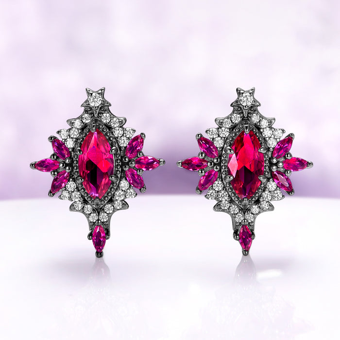 Nightbriar lab-grown ruby stud earrings in black ruthenium, marquise center stones in milgrain frames with ruby rays and a star crest