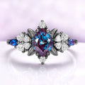 Lab-grown alexandrite engagement ring in black ruthenium showing the teal to violet color shift