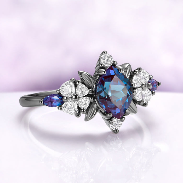 Angled view of the alexandrite center, black leaf frame and heart cut blossom shoulders