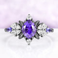 Purple sapphire engagement ring in black ruthenium with fantasy cut center and leaf frame