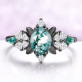 Marquise moss agate engagement ring in black ruthenium with leaf and heart cut accents