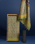 Olive green Katan silk unstitched suit set with small red and black paisley motifs, mustard yellow accents and a wide geometric printed border at the hem