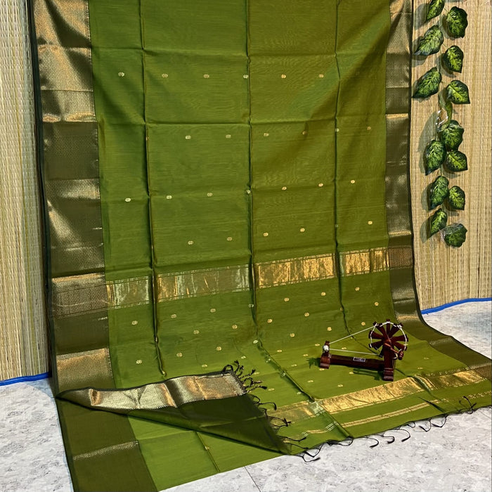 Olive green Maheshwari silk saree with evenly spaced small gold buti, a fine zari grid and metallic gold borders, handwoven in Maheshwar