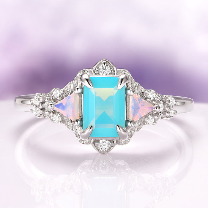 Opalescent Blue Sapphire Mermaid Engagement Ring in Sterling Silver by Aquamarise, featuring a rectangular light blue sapphire center flanked by triangular opalescent accents and sparkling diamonds on a delicate sterling silver band, part of Sterling Silver Rings, September Birthstone Jewelry, Engagement Rings for Women, and Nature-Inspired Engagement Rings collections.