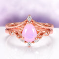 Opalescent Pink Sapphire Engagement Ring Set in 14K Rose Gold Vermeil featuring a pear-shaped pink sapphire with delicate diamond accents on a rose gold band by Aquamarise.