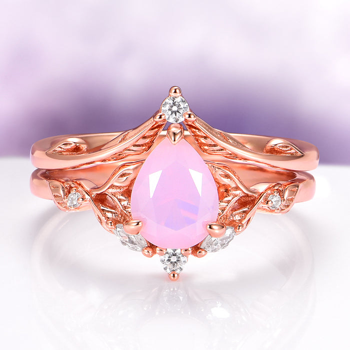Opalescent Pink Sapphire Engagement Ring Set in 14K Rose Gold Vermeil featuring a pear-shaped pink sapphire with delicate diamond accents on a rose gold band by Aquamarise.