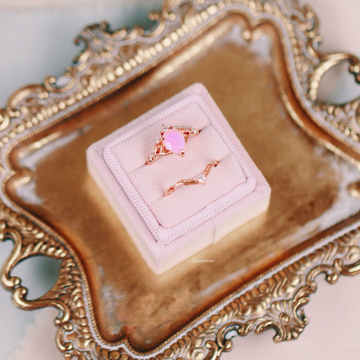 Opalescent Pink Sapphire Engagement Ring Set in 14K Rose Gold Vermeil by Aquamarise, displayed on a pink velvet holder atop an ornate gold tray, highlighting romantic elegance.