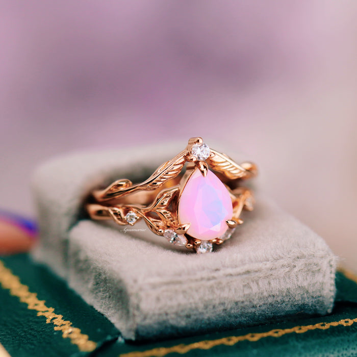 Opalescent Pink Sapphire Engagement Ring Set in 14K Rose Gold Vermeil by Aquamarise featuring a pear-shaped opalescent pink sapphire with floral-inspired rose gold bands and diamond accents.