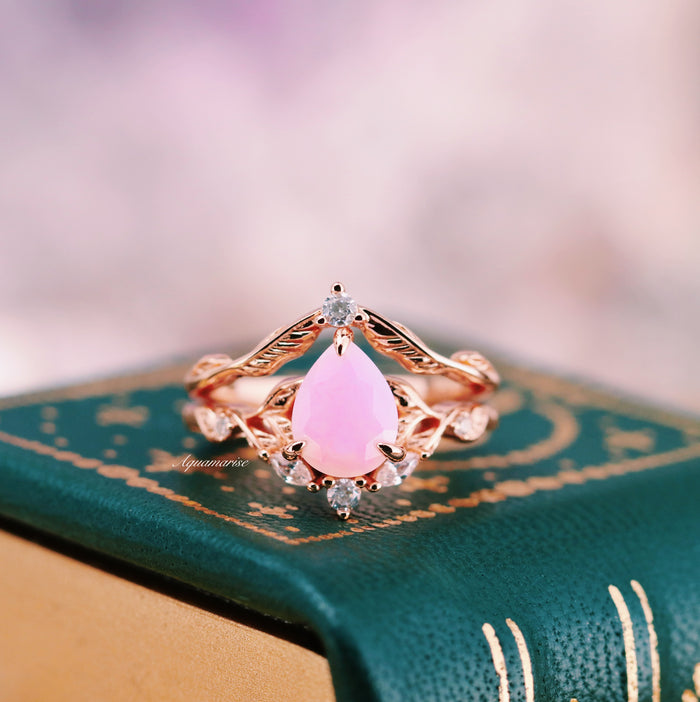 Opalescent Pink Sapphire Engagement Ring Set in 14K Rose Gold Vermeil with a pear-shaped pink sapphire and diamond accents on a nature-inspired rose gold band by Aquamarise.