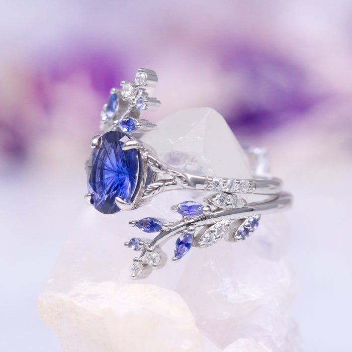 Orion Nebula™ & Cornflower Sapphire Leaf Couples Ring Set by Aquamarise featuring a silver band with a marquise-cut cornflower sapphire center stone and delicate leaf-inspired accents with small sapphire and diamond details, part of Matching Couples' Rings and September Birthstone Jewelry collections.