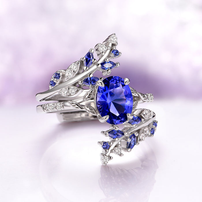 Orion Nebula™ & Cornflower Sapphire Leaf Couples Ring Set by Aquamarise featuring an intricately designed silver band with a vibrant cornflower sapphire centerpiece and leaf-inspired accents adorned with small sapphires and diamonds, part of Matching Couples' Rings, September Birthstone Jewelry, Leaf Rings, and Orion Nebula Rings® collections.