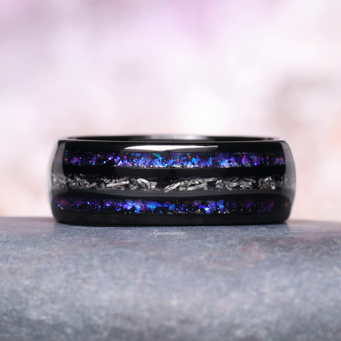 Faye Galaxy Orion Nebula™ & Sapphire Couples Ring Set featuring a polished black finish band accented with striking blue and purple sapphire flakes alongside textured metallic details, part of Aquamarise’s Matching Couples' Rings and Orion Nebula Rings® collections.