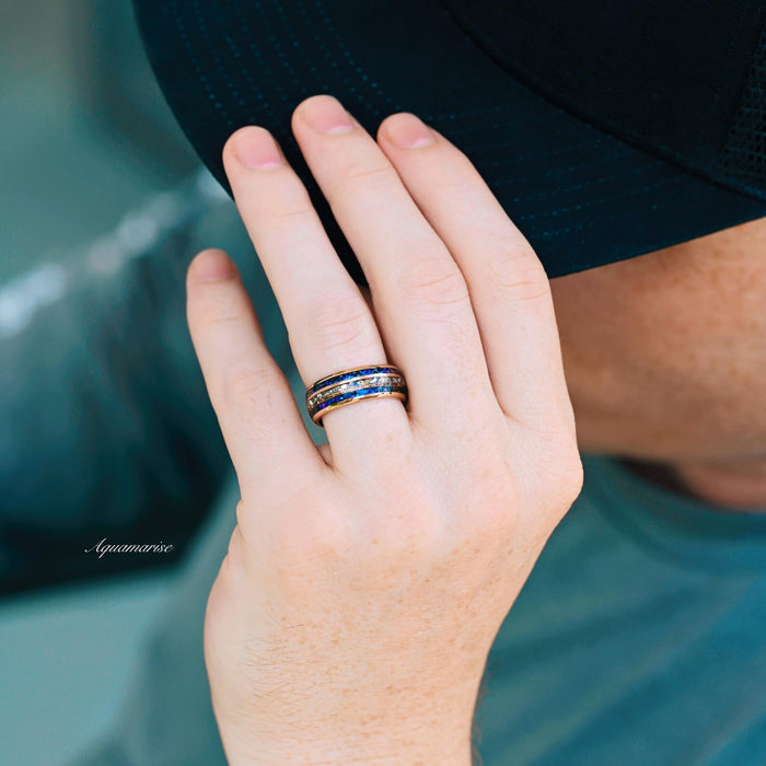 Hand wearing the Orion Nebula™ & Crushed Diamond Couples Ring Set by Aquamarise, featuring cosmic-inspired bands with crushed simulated diamonds and celestial blue accents.