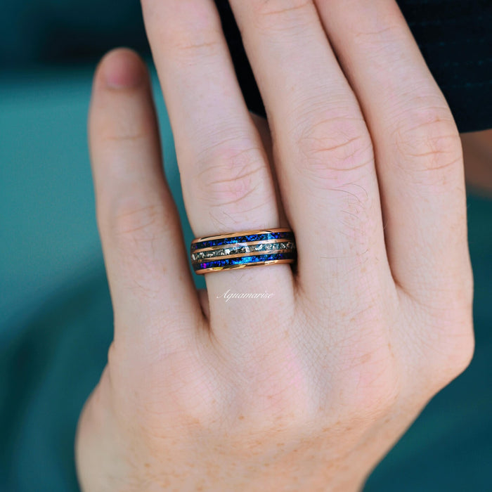Hand wearing the Orion Nebula™ & Crushed Diamond Couples Ring Set by Aquamarise, featuring deep blue and crushed simulated diamond inlays with a celestial design.