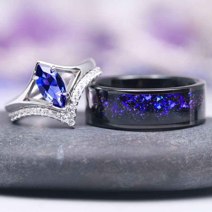 Natural Tanzanite Chevron Ring Set in 14K White Gold (two-piece) featuring a marquise-cut violet-blue tanzanite centerpiece with diamond accents alongside a black band inlaid with shimmering blue flakes, crafted by Aquamarise Gold.