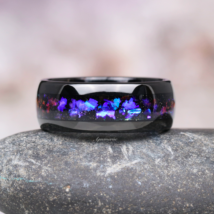 Orion Nebula™ & Tanzanite Couples Ring Set by Aquamarise featuring a polished black band with vibrant blue and purple tanzanite inlay, symbolizing cosmic love and unity.
