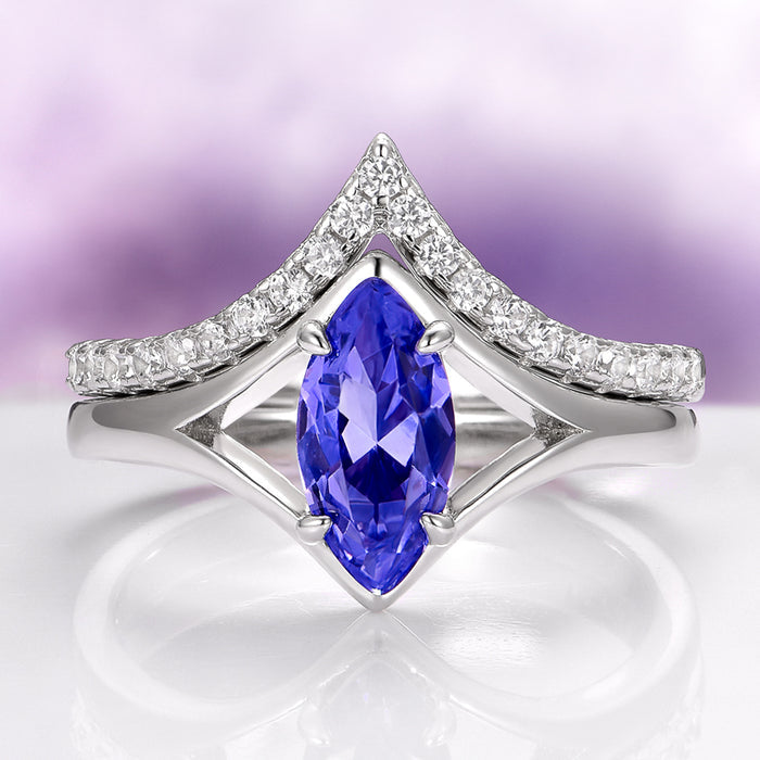 Natural Tanzanite Chevron Ring Set in 14K White Gold (two-piece) by Aquamarise Gold featuring a marquise-cut violet-blue tanzanite gemstone framed by a chevron-shaped band adorned with sparkling white diamonds, part of Solid Gold Engagement Rings and December Birthstone collections.