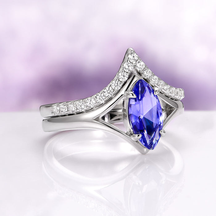 Natural Tanzanite Chevron Ring Set in 14K White Gold (two-piece) featuring a marquise-cut violet-blue tanzanite centerpiece accented by a chevron-shaped band with sparkling diamonds, crafted by Aquamarise Gold.