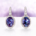 Oval Alexandrite Dangle Earrings in Sterling Silver by Aquamarise, featuring vibrant oval alexandrite stones surrounded by sparkling diamonds on polished sterling silver settings.