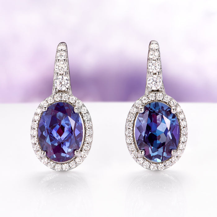 Oval Alexandrite Dangle Earrings in Sterling Silver by Aquamarise, featuring vibrant oval alexandrite stones surrounded by sparkling diamonds on polished sterling silver settings.