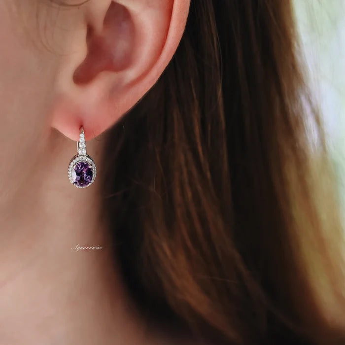Oval Alexandrite Dangle Earrings in Sterling Silver by Aquamarise, featuring a deep purple oval alexandrite stone with sparkling diamond accents on polished sterling silver settings.