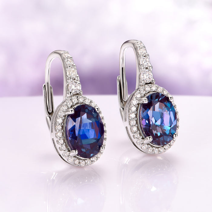 Oval Alexandrite Dangle Earrings in Sterling Silver by Aquamarise, featuring color-changing oval stones surrounded by sparkling diamonds on polished sterling silver settings.