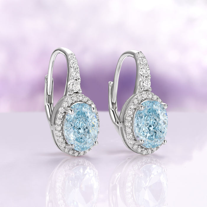 Oval Aquamarine Drop Earrings in Sterling Silver by Aquamarise, showcasing shimmering oval aquamarine stones surrounded by sparkling simulated diamonds on polished sterling silver settings.