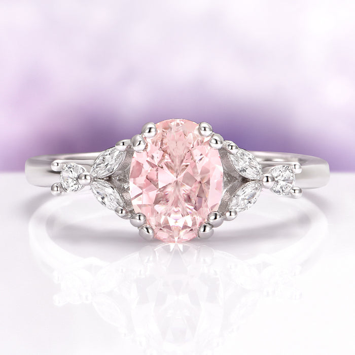 Oval Cut Blush Pink Morganite Ring in Sterling Silver by Aquamarise featuring a vintage-inspired oval peachy-pink morganite with delicate leaf and diamond accents in a sterling silver band.