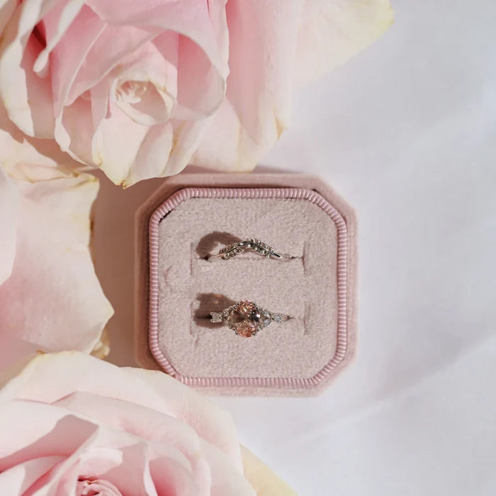 Oval Cut Blush Pink Morganite Ring in Sterling Silver by Aquamarise shown in a pale pink velvet box surrounded by soft pink roses, highlighting its delicate vintage-inspired design.