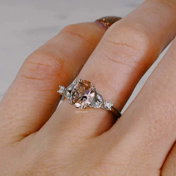 Oval Cut Blush Pink Morganite Ring in Sterling Silver by Aquamarise displayed on finger, featuring a soft peachy-pink morganite with sparkling accents in a vintage-inspired design.