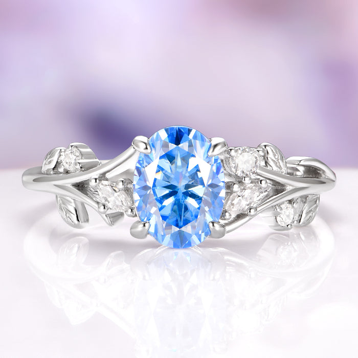 Silver ring with a blue gemstone on a white background
