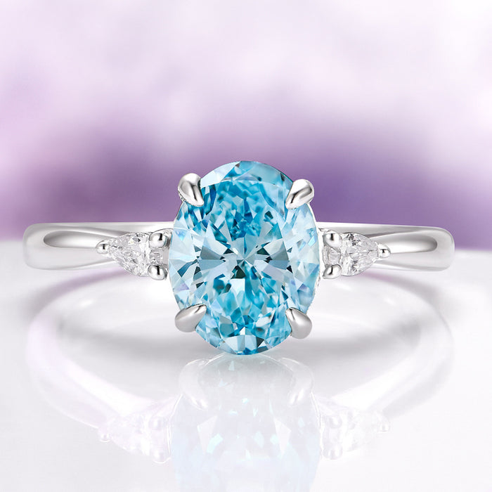 Oval Cut Natural Swiss Topaz Engagement Ring in Sterling Silver by Aquamarise, showcasing a sparkling oval Swiss blue topaz center with delicate side accents, part of Sterling Silver Rings, November Birthstone, and Engagement Rings for Women collections.