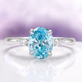 Oval Cut Natural Swiss Topaz Engagement Ring in Sterling Silver by Aquamarise, showcasing a sparkling oval Swiss blue topaz center with delicate side accents, part of Sterling Silver Rings, November Birthstone, and Engagement Rings for Women collections.