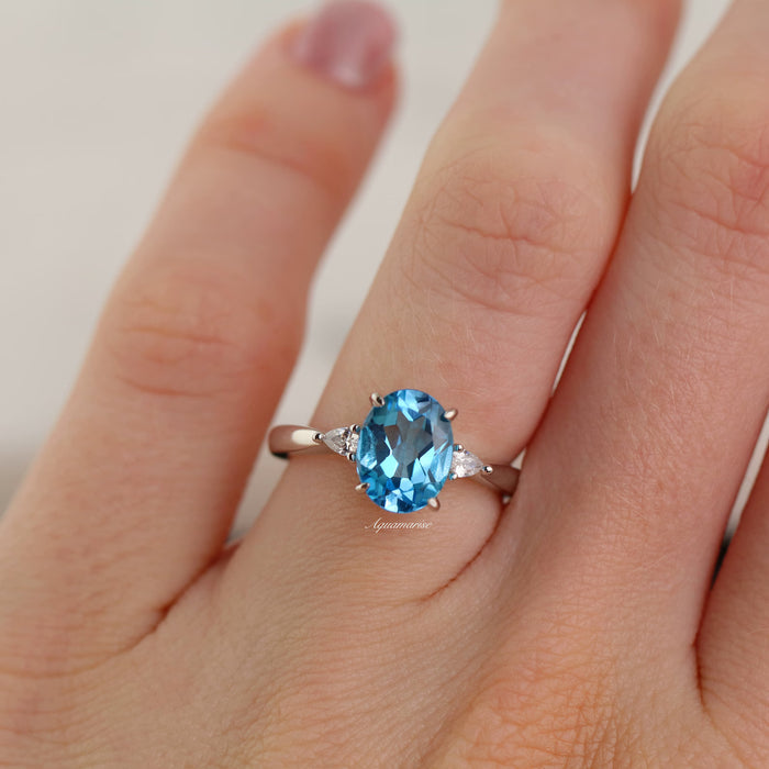 Oval Cut Natural Swiss Topaz Engagement Ring in Sterling Silver by Aquamarise, featuring a vibrant oval Swiss blue topaz center stone accented with delicate side stones, part of Sterling Silver Rings, November Birthstone, and Engagement Rings for Women collections.