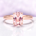 Oval Solitaire Morganite Engagement Ring in 14K Rose Gold Vermeil by Aquamarise, featuring a 2-carat peachy-pink simulated morganite set in a minimalist polished rose gold band.
