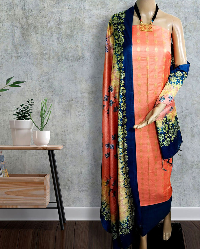 Peach Katan silk suit set with a dark blue border and a contrast dark blue dupatta, hand block printed with repeating circular geometric motifs in gold and yellow.