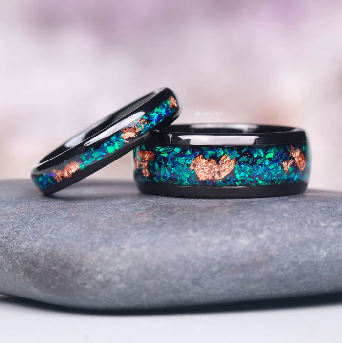 Peacock Fire Opal & Rose Gold Leaf Couples Ring Set by Aquamarise featuring vibrant green and blue fire opal with rose gold leaf accents in sleek black bands, perfect for matching couples rings.