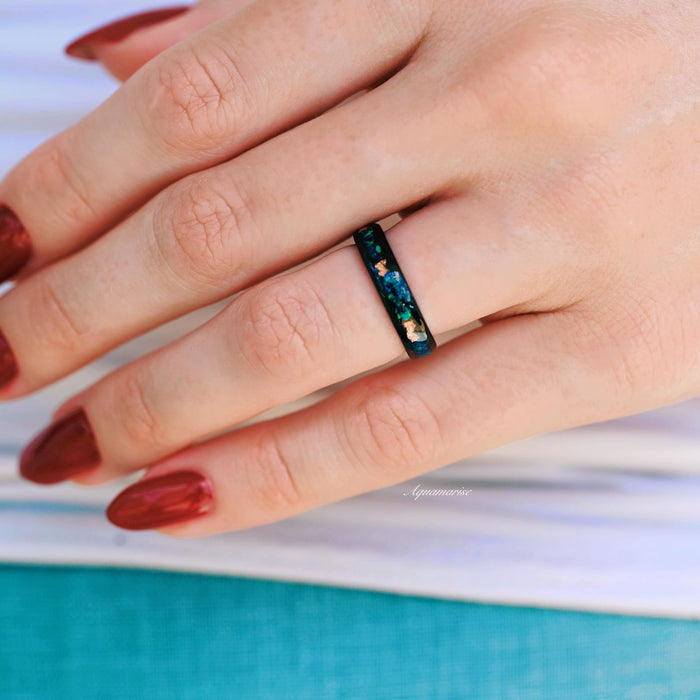 Peacock Fire Opal Wedding Band- 4MM His/ Hers Black Tungsten Wedding Ring worn on hand, showcasing vibrant blue and green crushed fire opal inlay by Aquamarise.