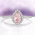 Ring with a pink diamond and diamond halo on a light purple background