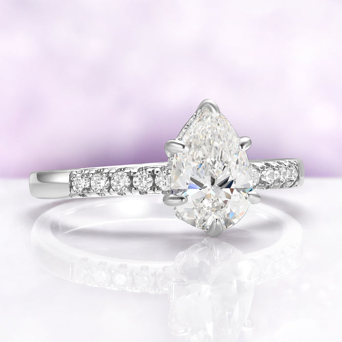 Pear White Sapphire Art Deco Bridal Ring Set in Sterling Silver by Aquamarise, featuring a pear-shaped white sapphire with diamond accents on a polished sterling silver band.