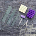 Pet grooming kit including combs, dog shampoo bar, grooming brush, and clippers for dogs and cats.