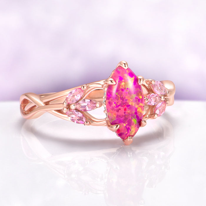 Pink Fire Opal & Sapphire Celtic Knot Ring in 14K Rose Gold Vermeil by Aquamarise, featuring a vibrant pink fire opal marquise center with sapphire accents in an intricate rose gold knot design.