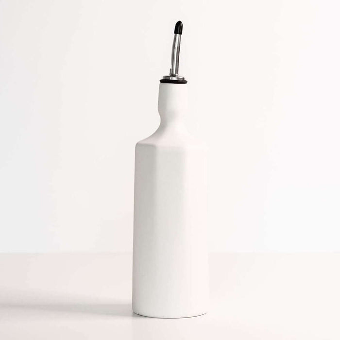 Elixir handcrafted porcelain olive oil dispenser in silk white color on a minimalist kitchen countertop.