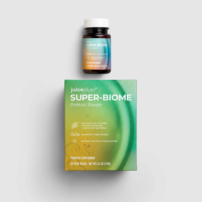 Juiceplus Super-Biome Probiotic Powder shown with its green and yellow product box and a small dark bottle with a white cap on a light gray background.