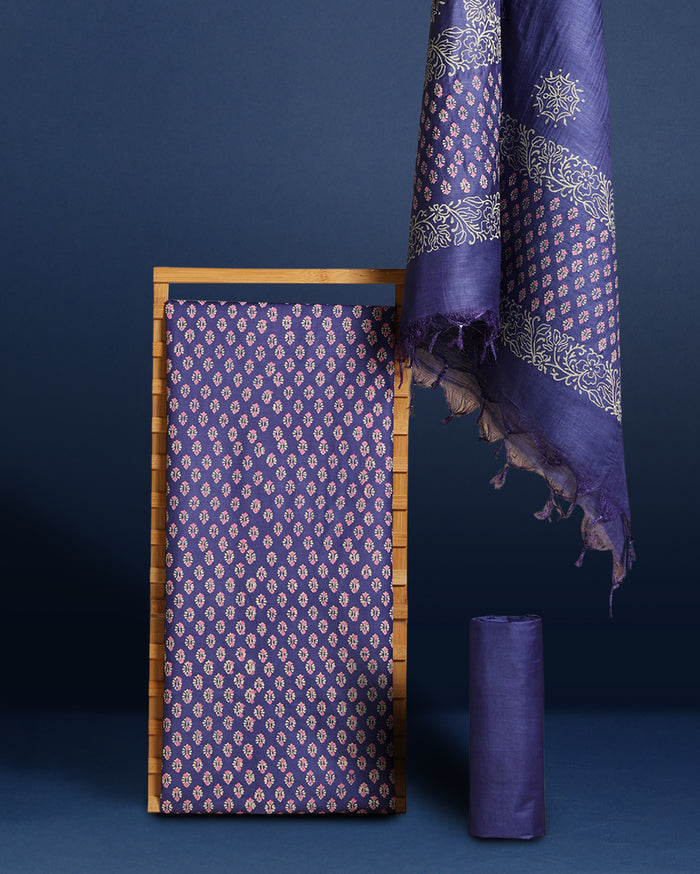Purple katan silk unstitched suit set hand block printed with small off-white and pale pink botanical motifs, with a panelled dupatta ending in a short self fringe.