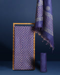Purple katan silk unstitched suit set hand block printed with small off-white and pale pink botanical motifs, with a panelled dupatta ending in a short self fringe.