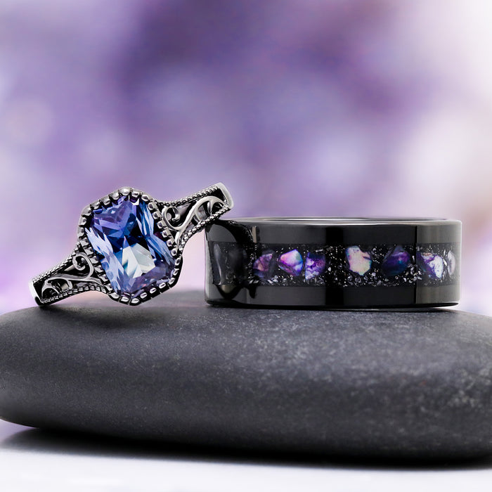 Radiant Cut Alexandrite Engagement Ring in Black Ruthenium by Aquamarise, featuring an ornate vintage-inspired band with a radiant cut alexandrite and a matching black ring with purple opal inlay.