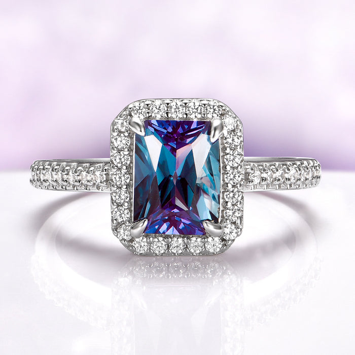 Radiant Cut Halo Alexandrite Ring in Sterling Silver by Aquamarise, featuring a vibrant purple-blue gemstone surrounded by sparkling silver pavé diamonds on the band and halo.