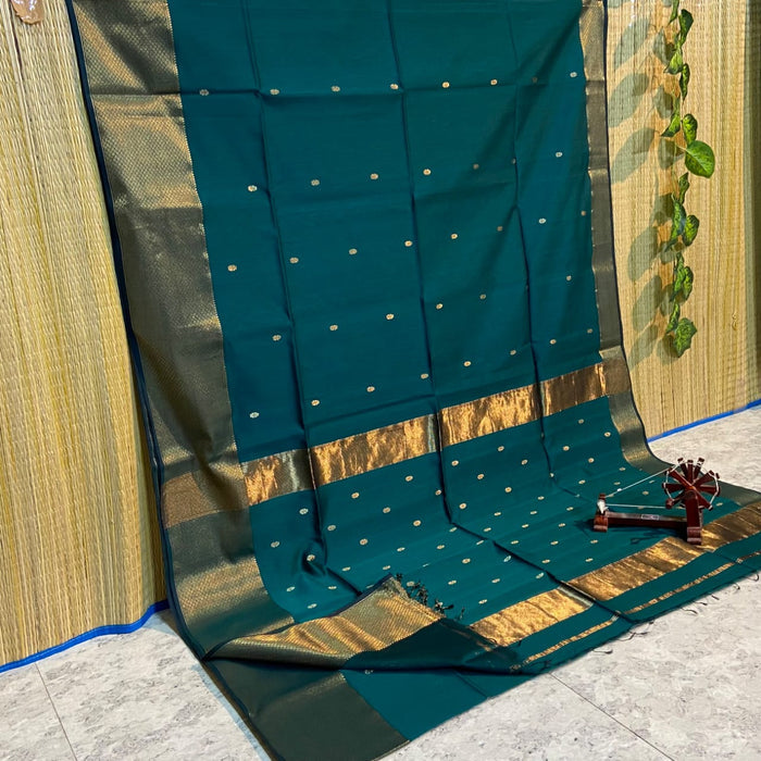 Handloom Maheshwari silk saree in rama green, flower buti scattered across the body, with a wide golden zari border
