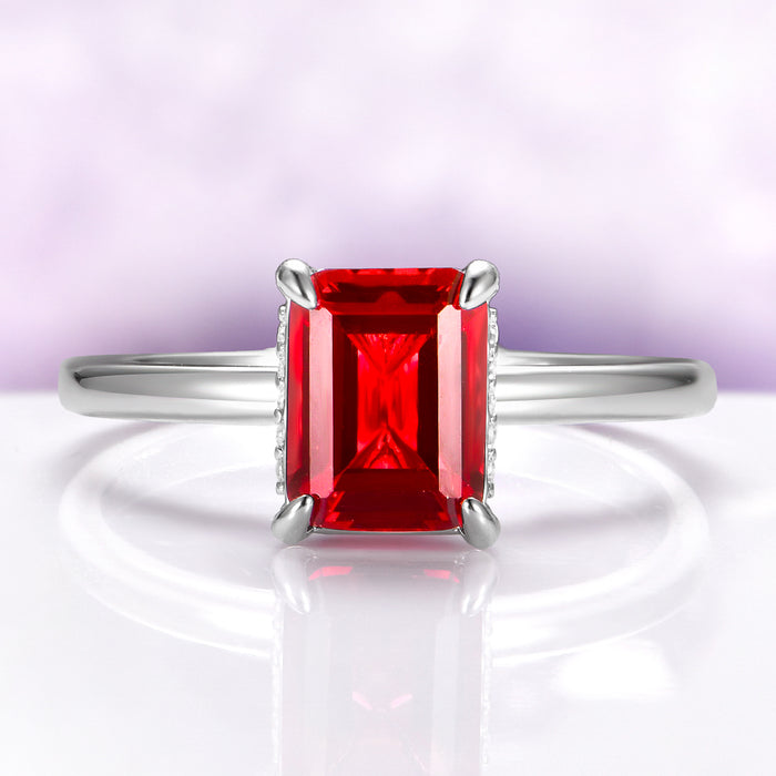 Raspberry Tourmaline Solitaire Engagement Ring in Sterling Silver with an emerald-cut red gemstone set in a minimalist polished band by Aquamarise, perfect for October birthstone jewelry.